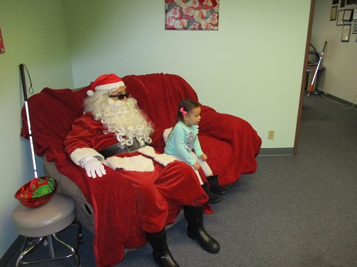 A blind girl sitting with Blind Santa